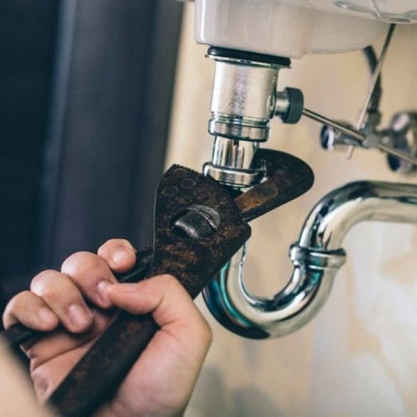 plumbing-service-image-Handeez-UK a plumber fixing a sink pipe
